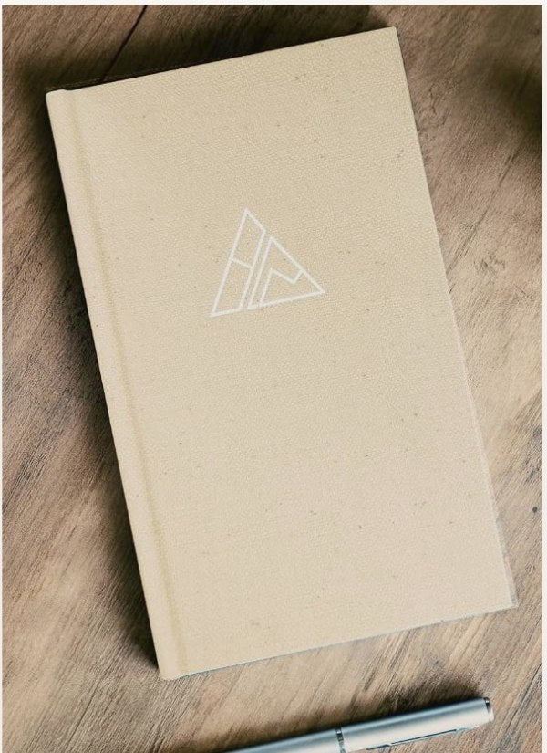 Self-Mastery Journal on a wood desk beside a pen